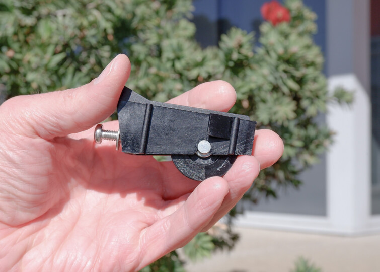Close-up of service technician holding the ROL31 roller from Jason Windows Spare Parts.